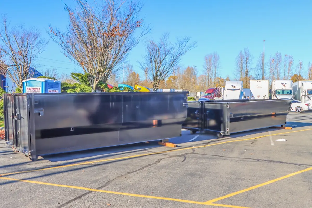 Professional dumpster rental service with roll-off container on residential driveway in Brookhaven
